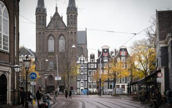 a city street with people walking and buildings